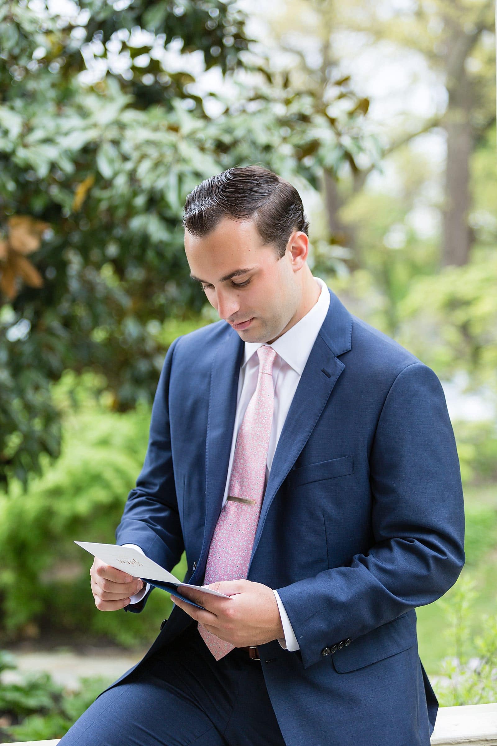 Groom reading a letter from his bride before the ceremony