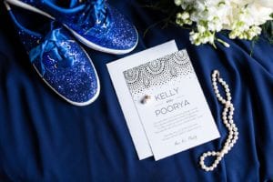 Blue Sequined Kate Spade Kids with bride's pearl necklace, wedding invitation inspiration