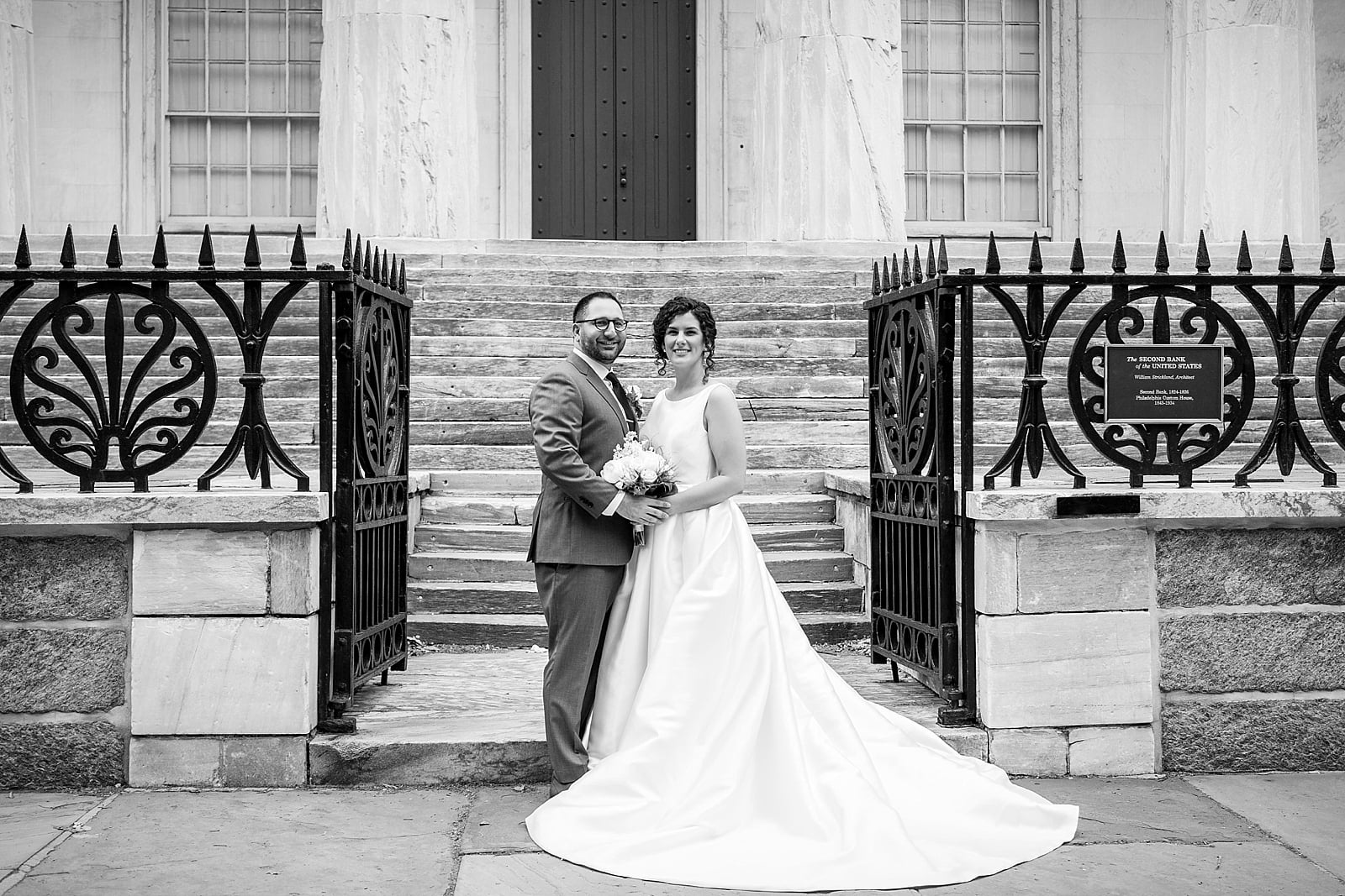 Black & white portrait in front of wrought iron gates at Philadelphia's Second National Bank