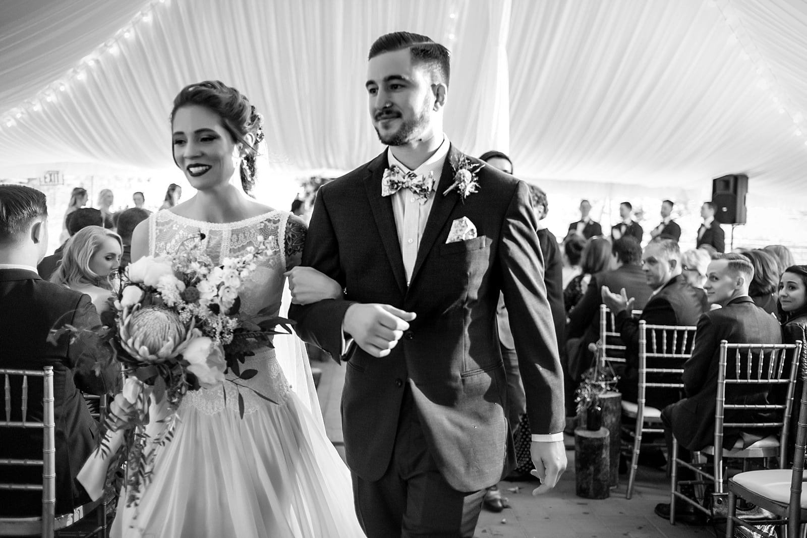 Black & white wedding portraits of tattooed bride and groom at the Inn at Millrace Pond