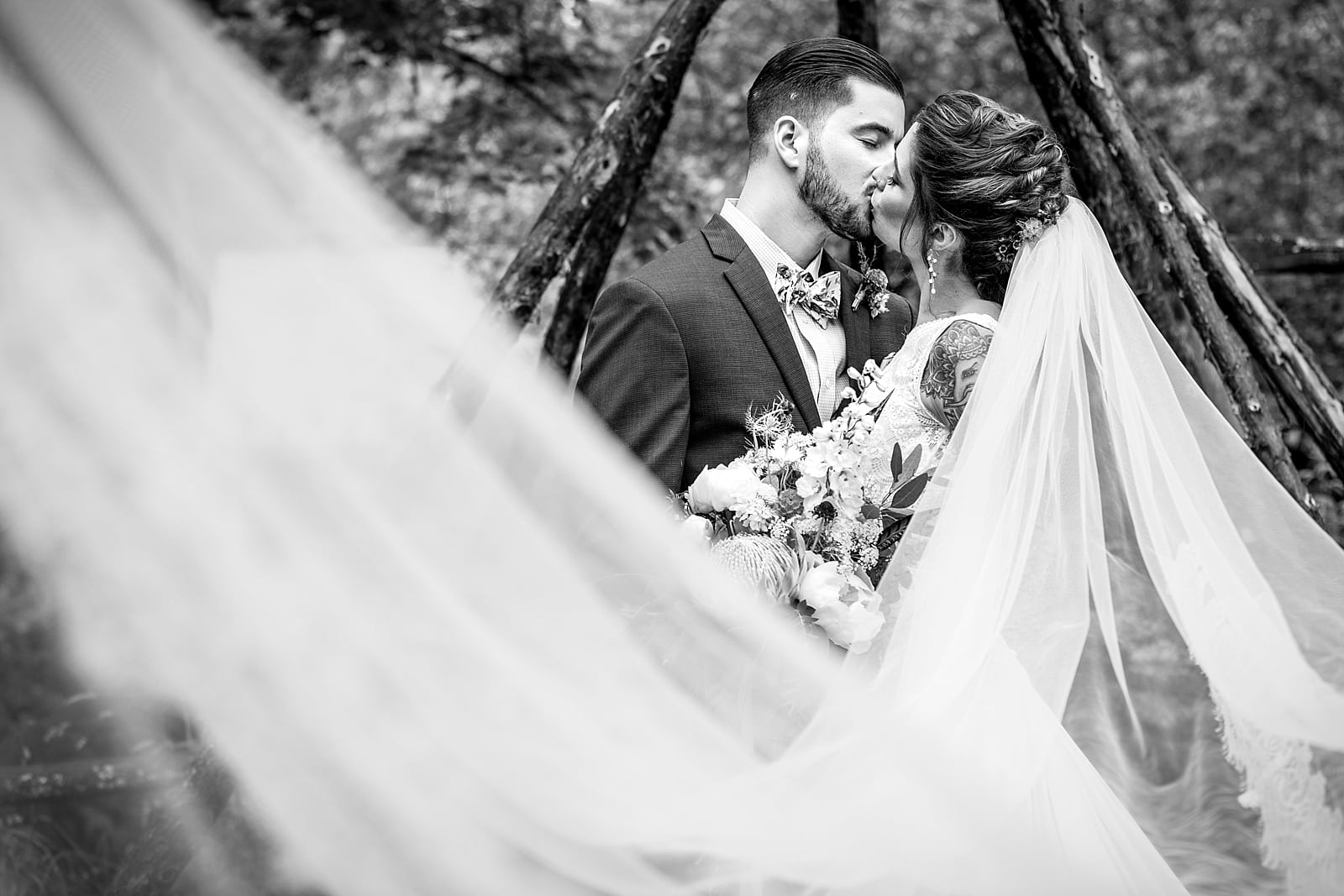 black & white wedding portraits of tattooed bride and groom at the Inn at Millrace Pond