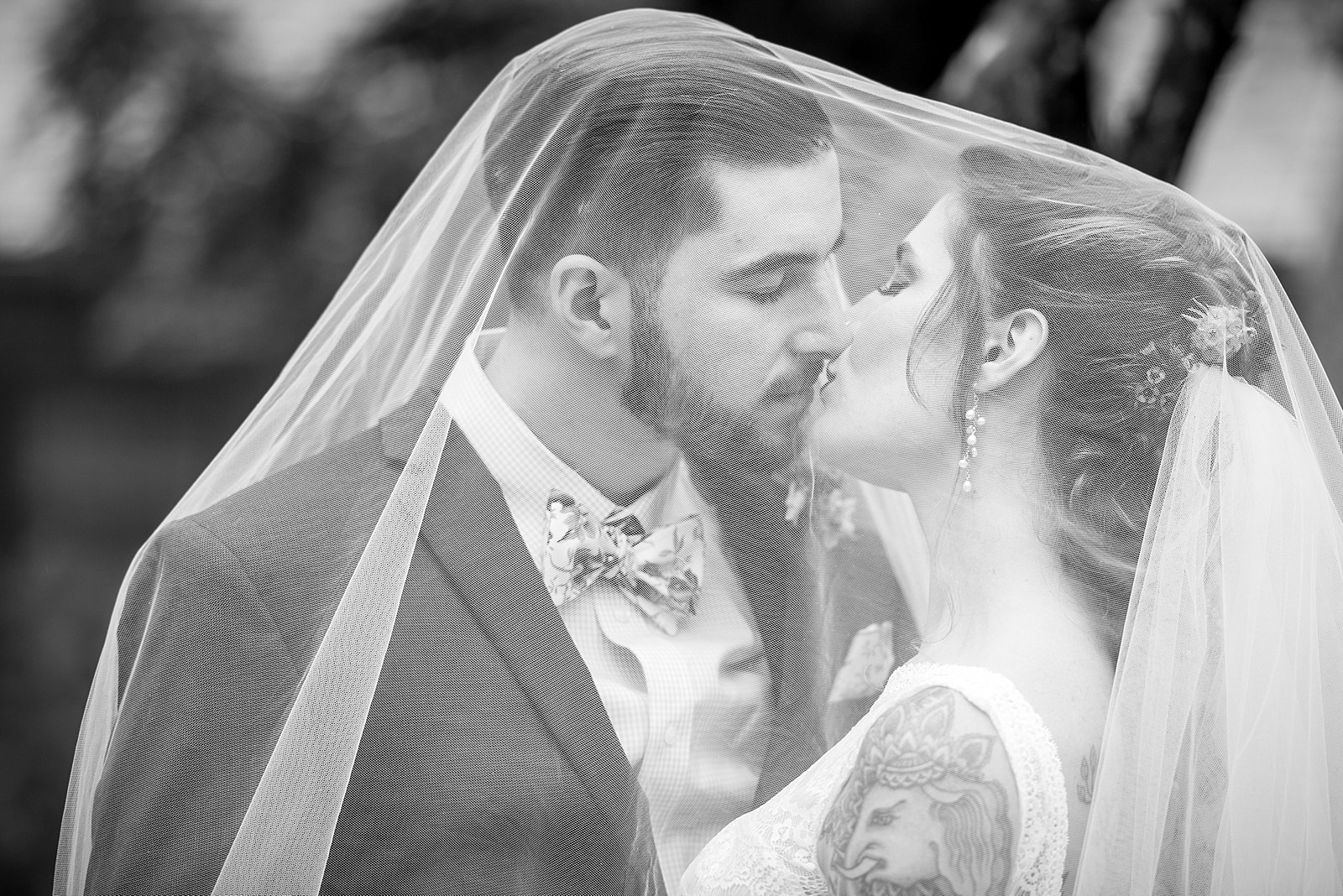 black & white wedding portraits of tattooed bride and groom at the Inn at Millrace Pond