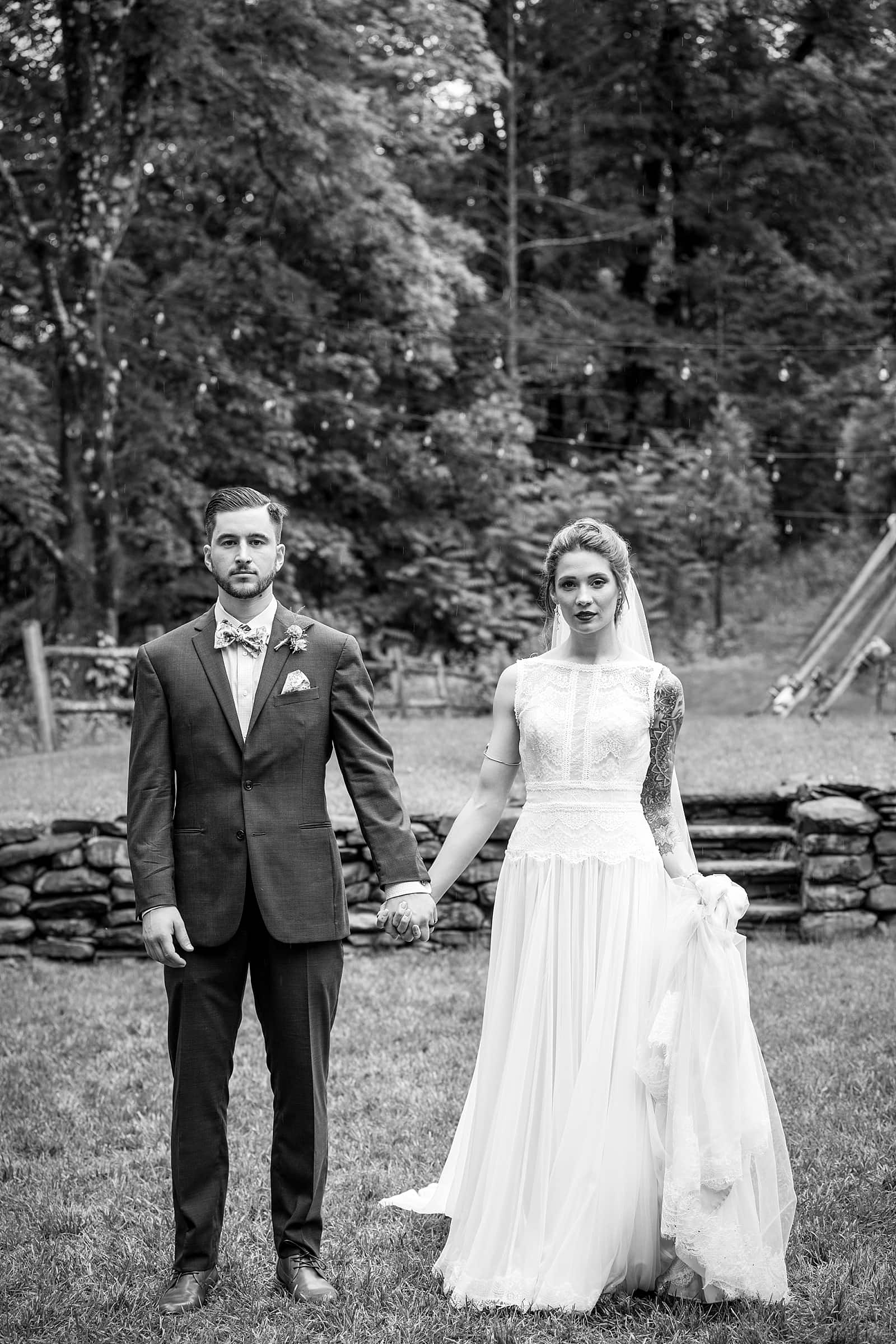 black & white wedding portraits of tattooed bride and groom at the Inn at Millrace Pond
