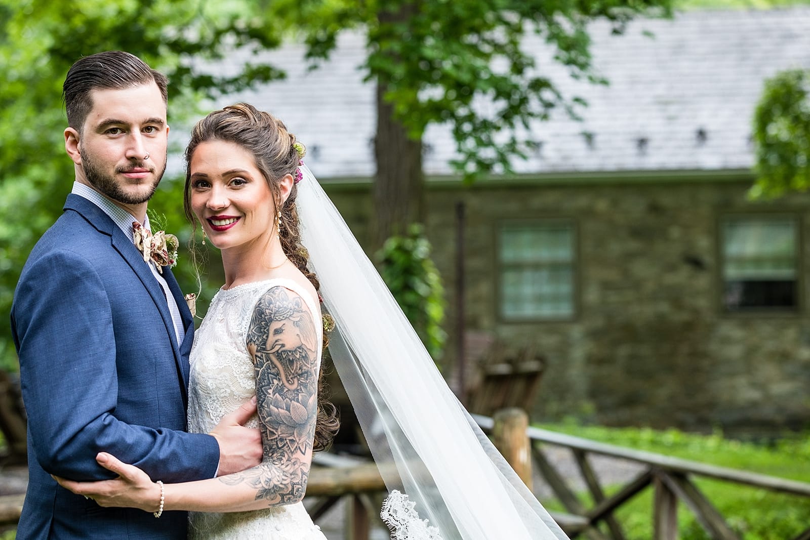 wedding portraits of tattooed bride and groom at the Inn at Millrace Pond