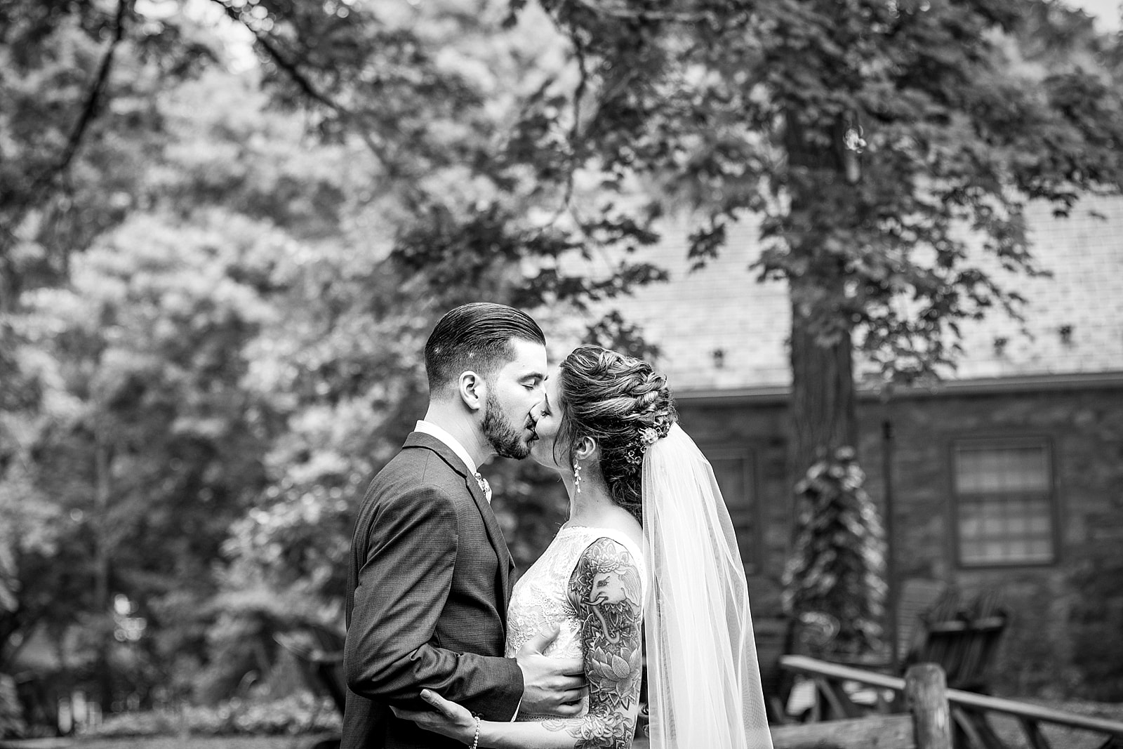 black & white wedding portraits of tattooed bride and groom at the Inn at Millrace Pond