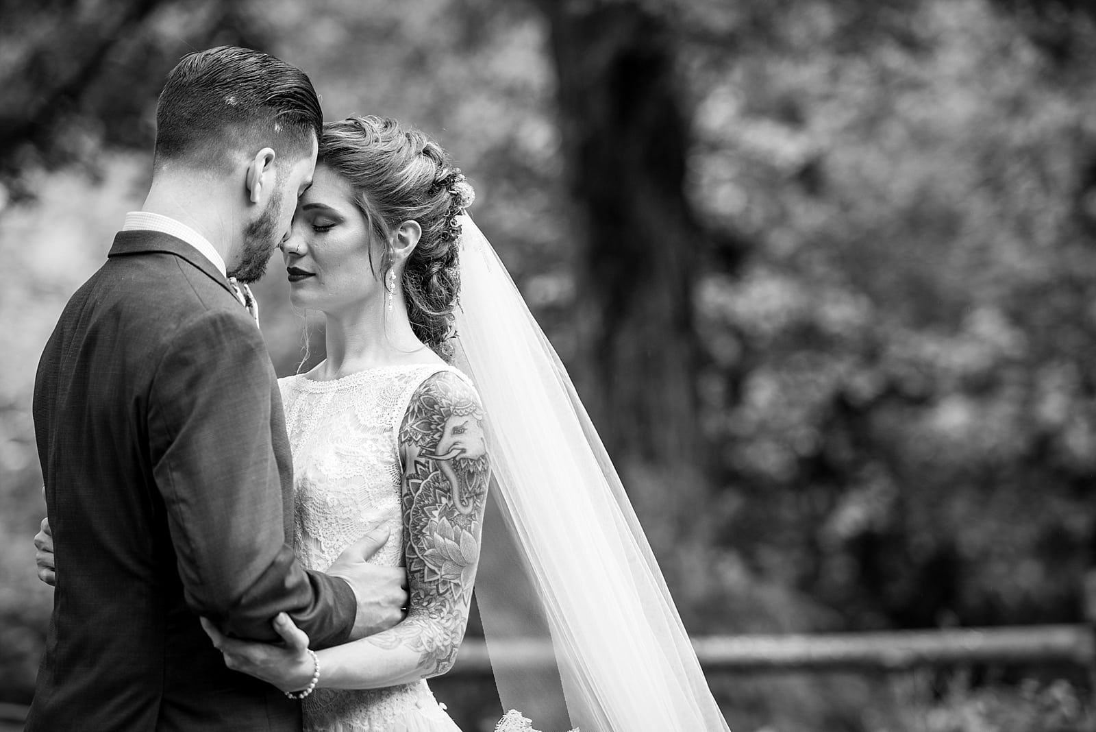 black & white wedding portraits of tattooed bride and groom at the Inn at Millrace Pond