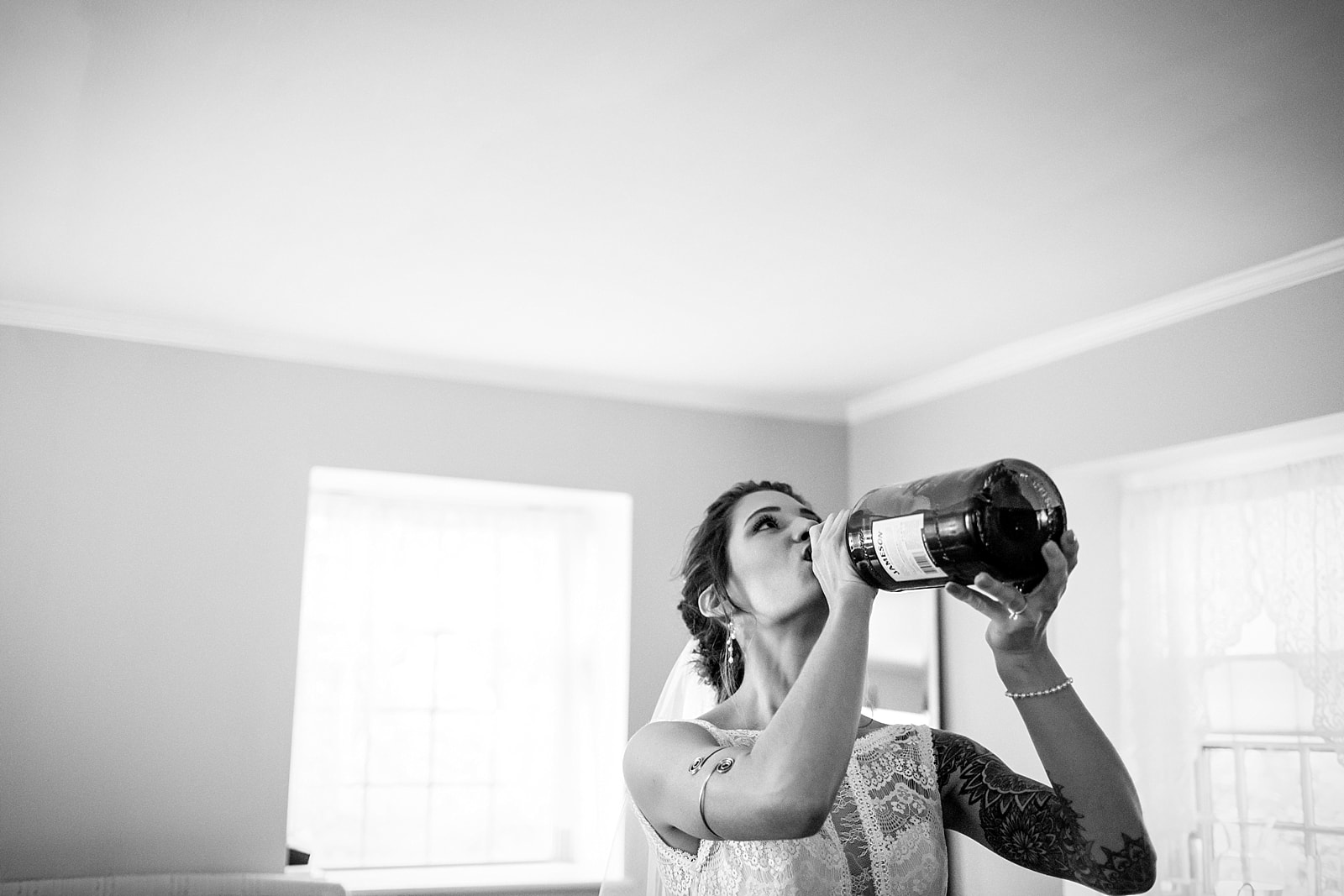 Bride takes a last minute shot of Jameson from the handle before she walks down the aisle