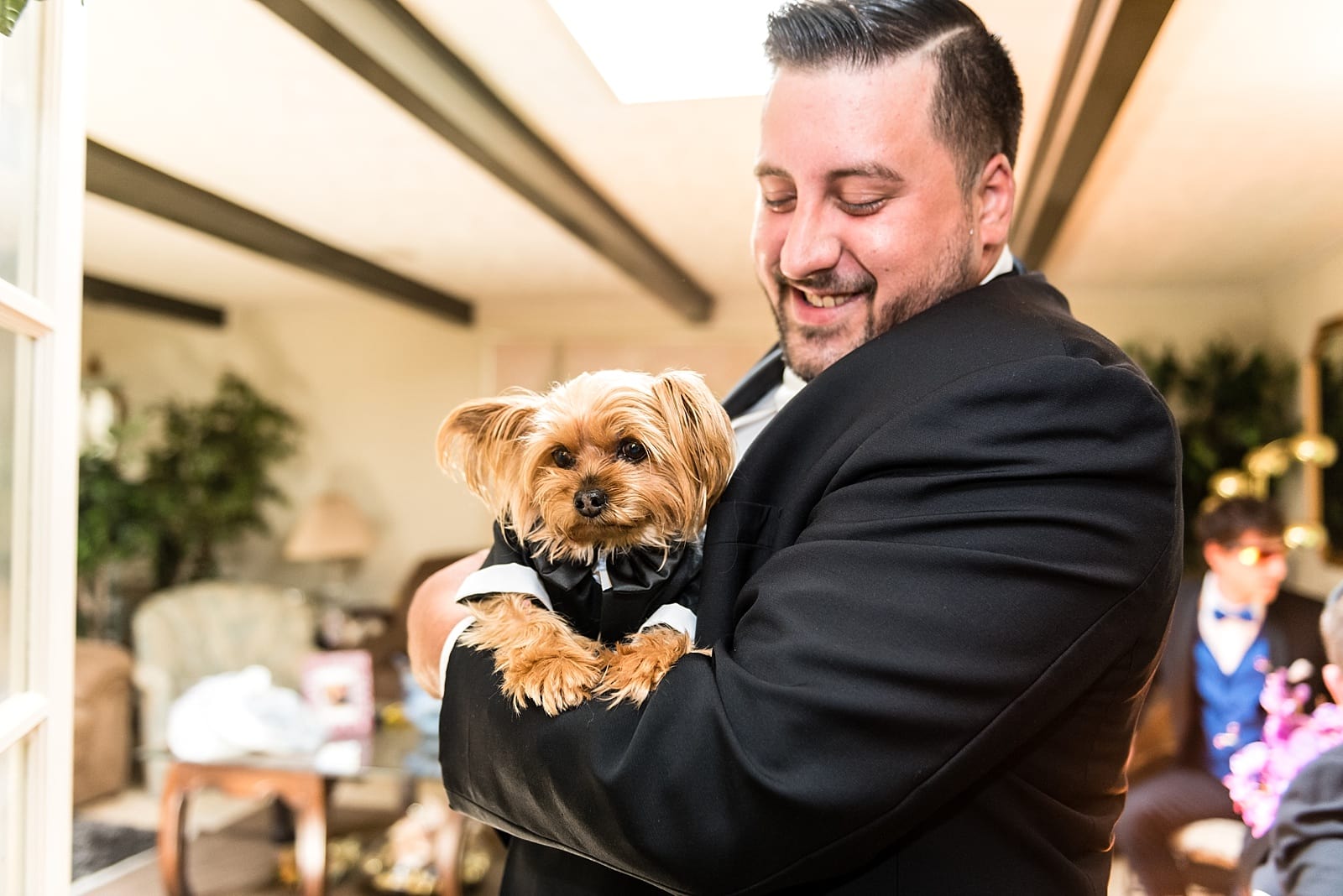 Frank poses with his dog, dressed in matching tuxedos