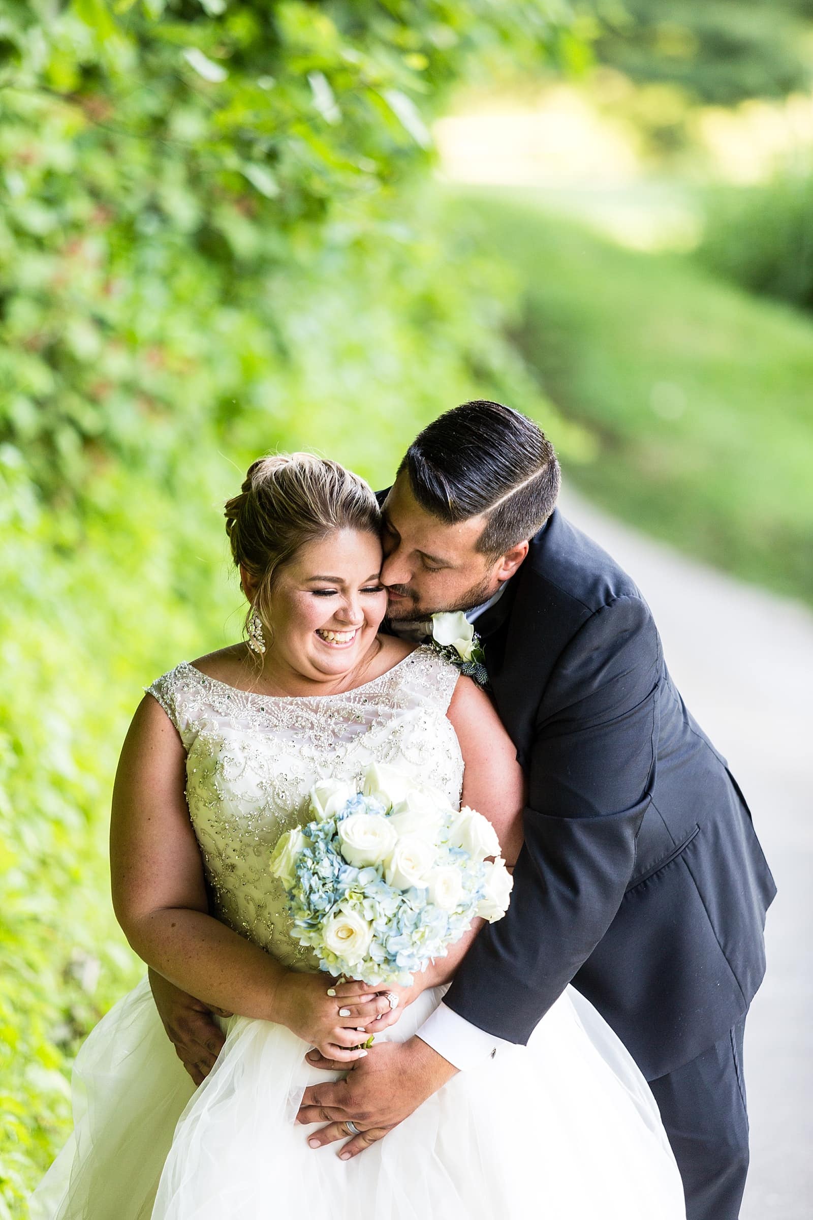 groom kissing bride at Anthony's at Paxon Hollow Country Club