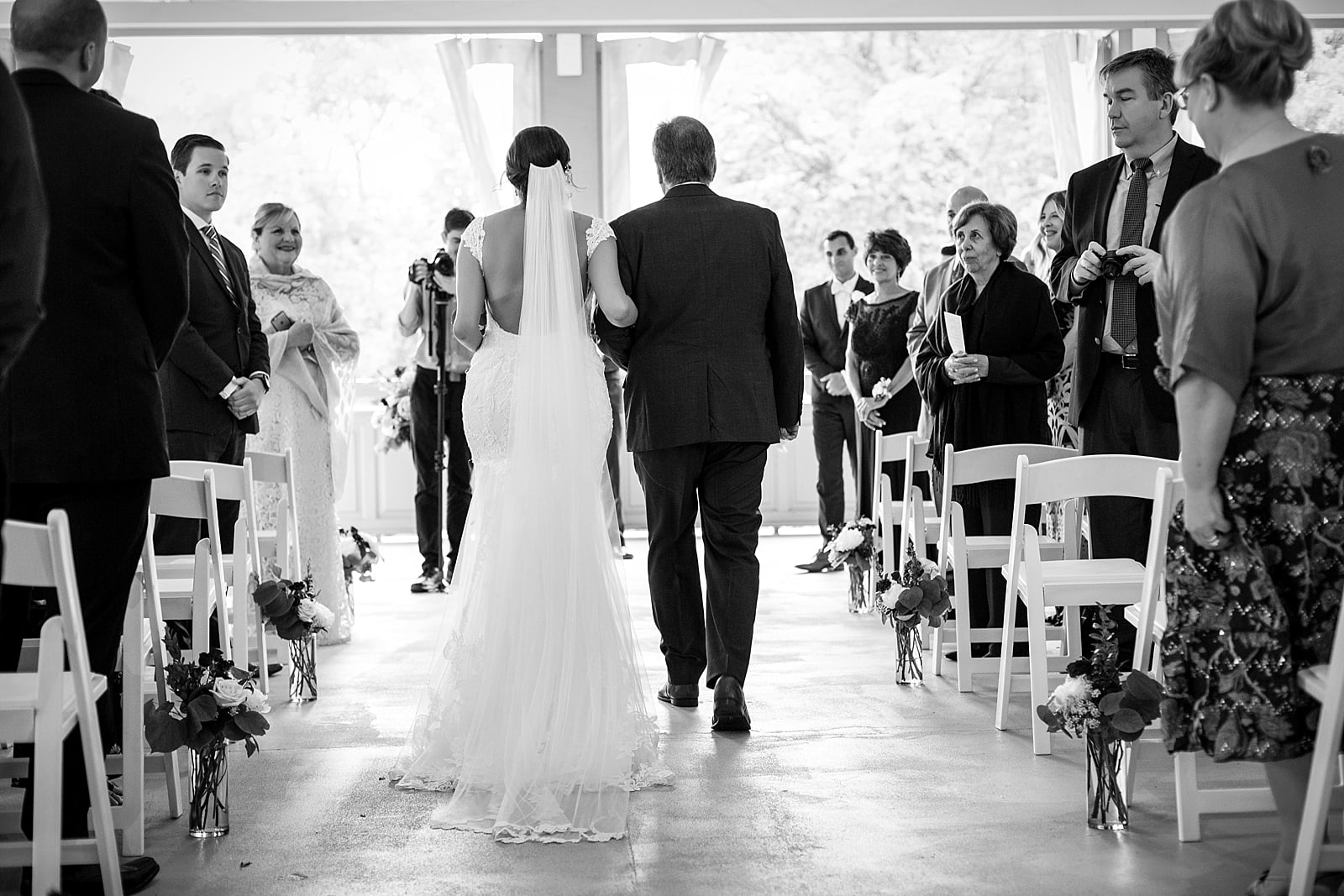 Bride and father of the bride walking down the aisle, wedding ceremony, black and white wedding photography, veil 