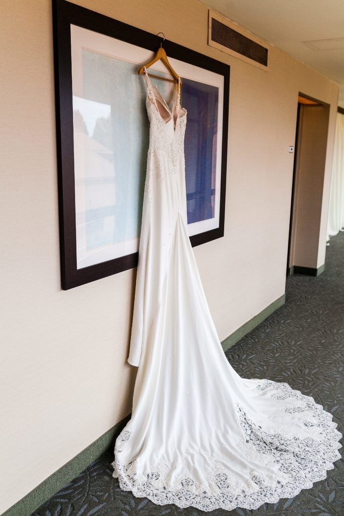 Wedding dress hanging on a piece of framed art