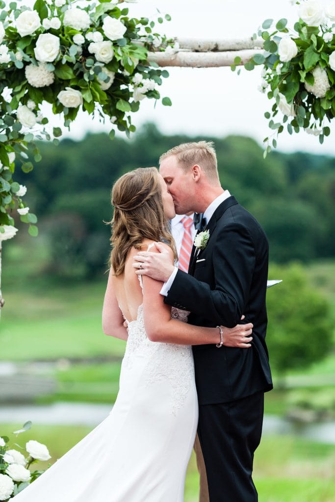 Bride & groom share their first kiss during their ceremony at Chubb Conference Center