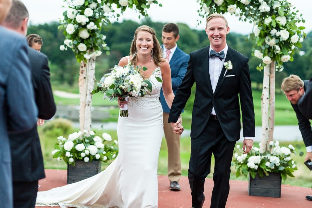 Bride & groom recess down the aisle during their ceremony at Chubb Conference Center