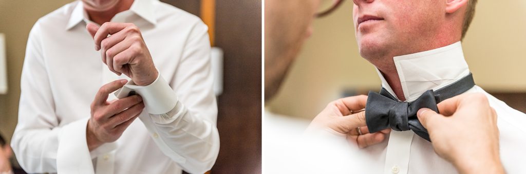 Groom getting ready by tying his bow tie