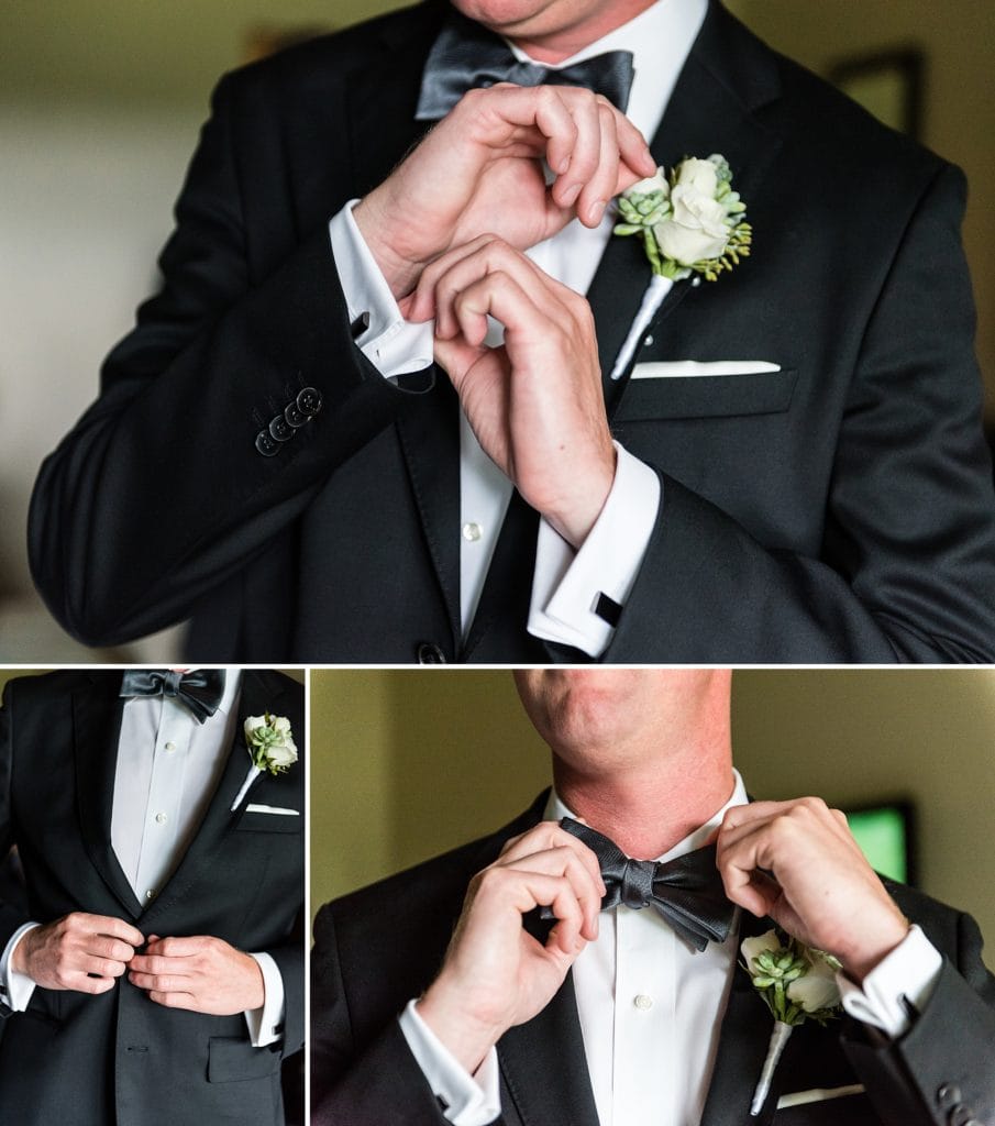 Groom getting ready by tying his bow tie