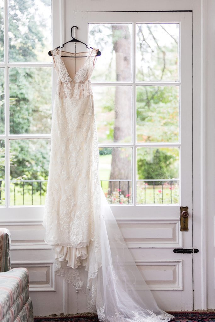 Galina Signature wedding dress hanging in the sunroom at the Collingswood Ballroom