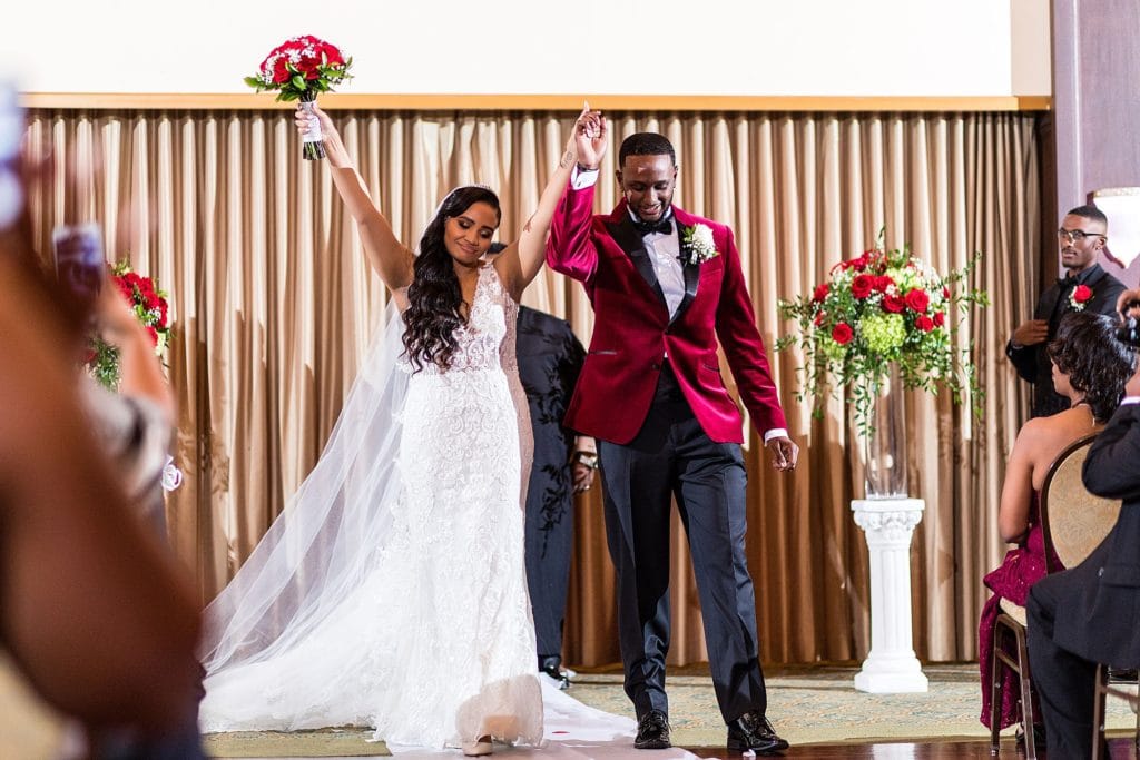 Bride & groom celebrate and dance down the aisle during their Collingswood Ballroom wedding ceremony
