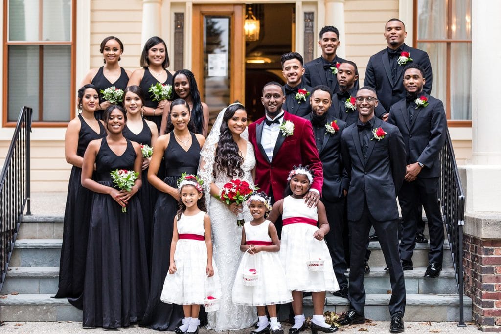 Bride & groom with their full wedding party on the steps of the Collingswood Ballroom