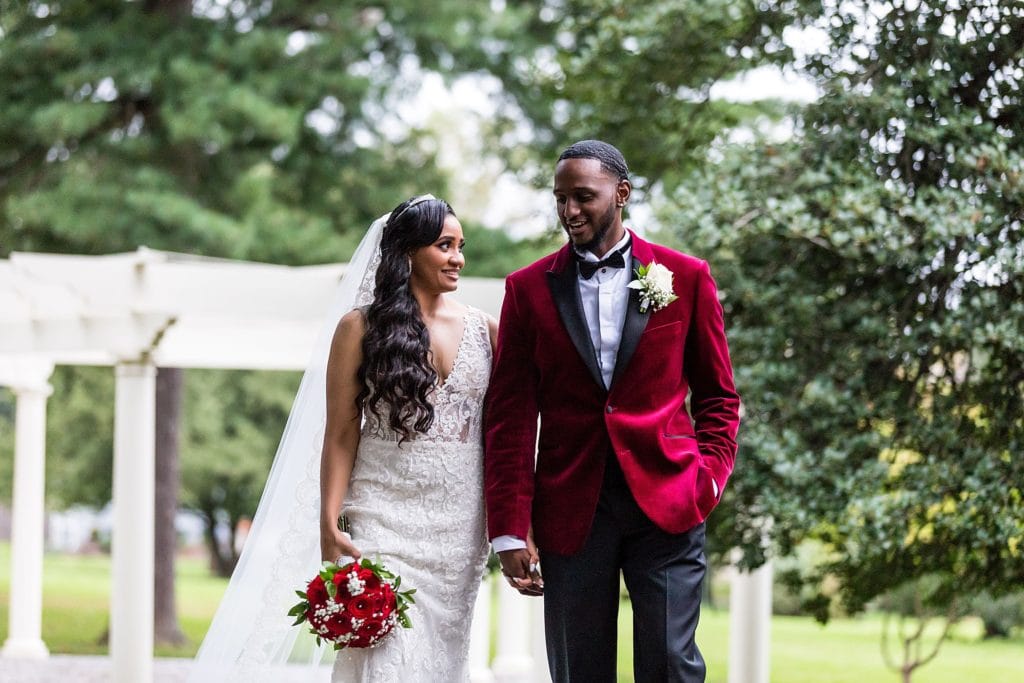 Bride & groom smile and walk hand in hand for their wedding portraits at their Collingswood Ballroom wedding