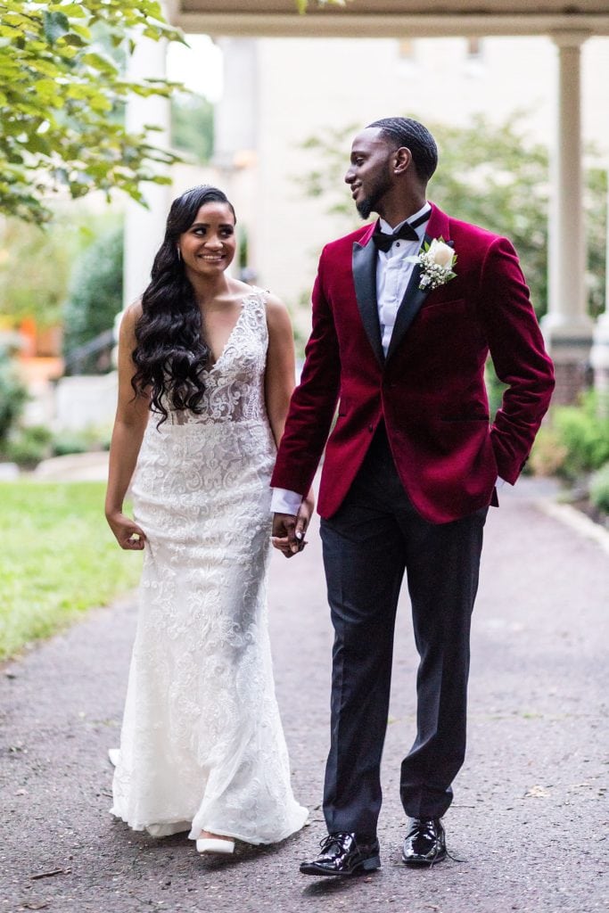 Bride & groom smile and walk hand in hand for their wedding portraits at their Collingswood Ballroom wedding
