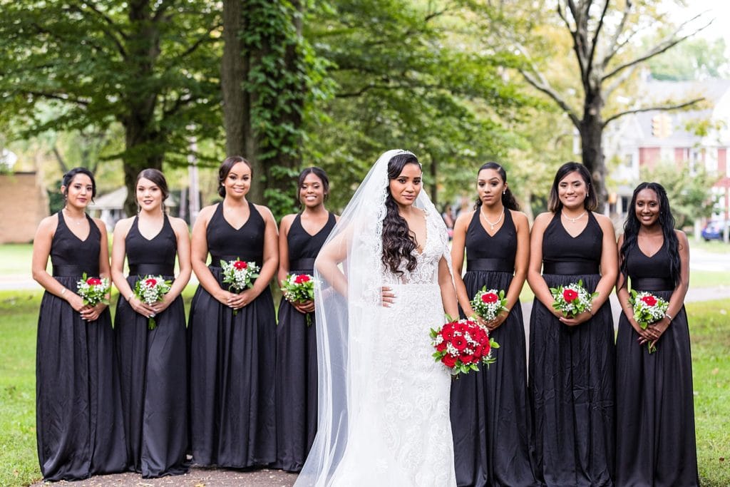 Bride wearing her Galina Signature wedding dress, with her bridesmaids dress in black together before her Collingswood Ballroom wedding