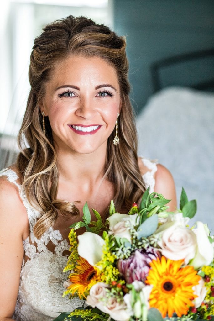 Window lit bridal portrait with a colorful wedding bouquet