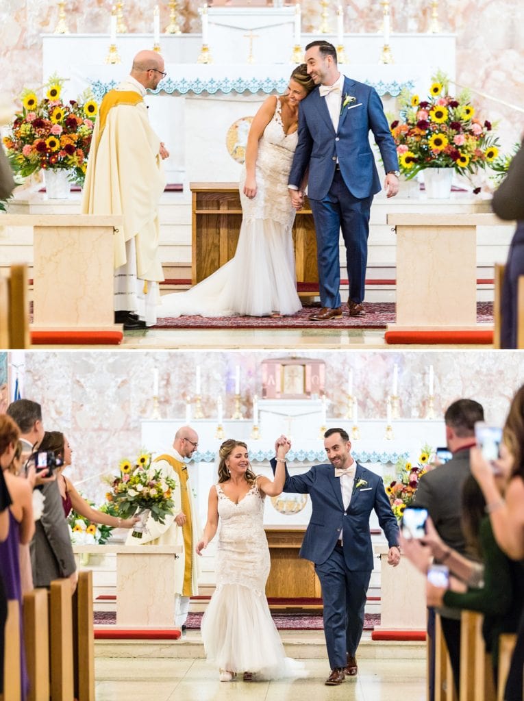 Bride and groom embrace as they walk down the aisle hand in hand during their catholic wedding ceremony at St Charles Borromeo