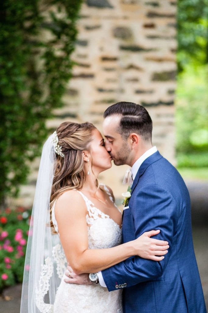 bride & groom kiss and embrace during their wedding photos