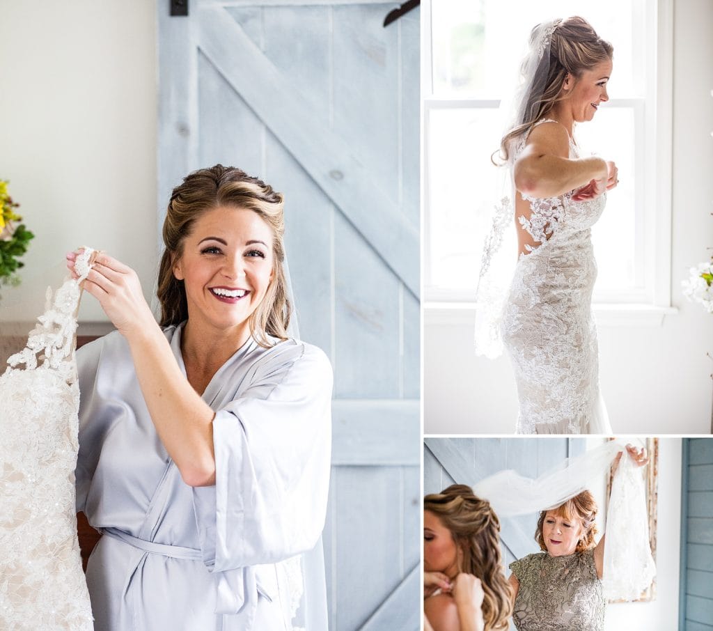 Bride smiles as she puts on her lace Watters dress with her mother