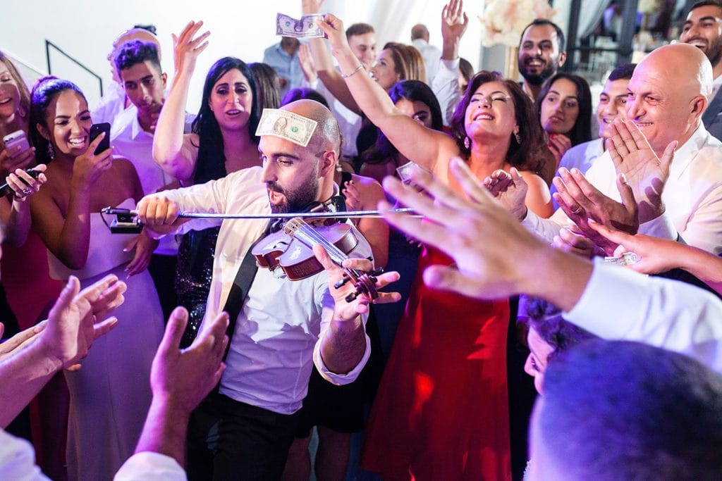 groom playing violin, dollar dance, jewish wedding reception, cultural wedding