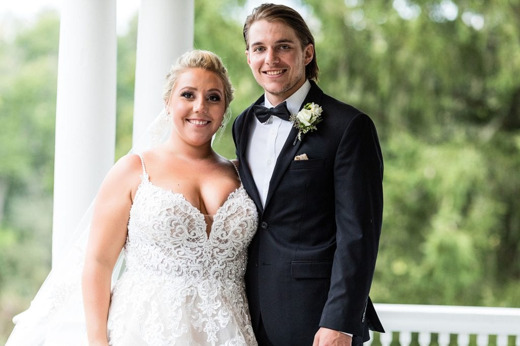 Bride & groom smile for a wedding photo at their John James Audubon Center wedding