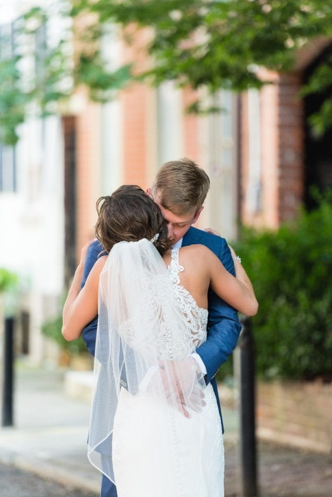 Bride & groom embrace each other after their first look on Addison St in Philadelphia before their Kimmel Center wedding