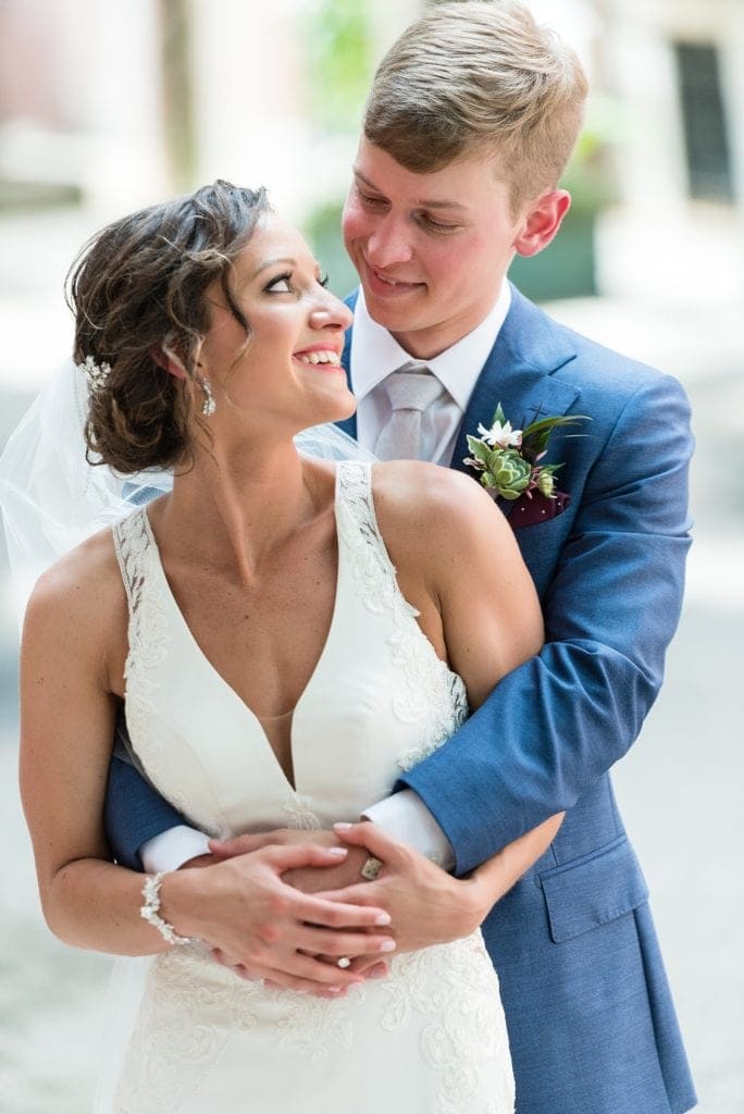 Bride & Groom embrace for wedding portraits on Addison St in Philadelphia before their Kimmel Center Wedding