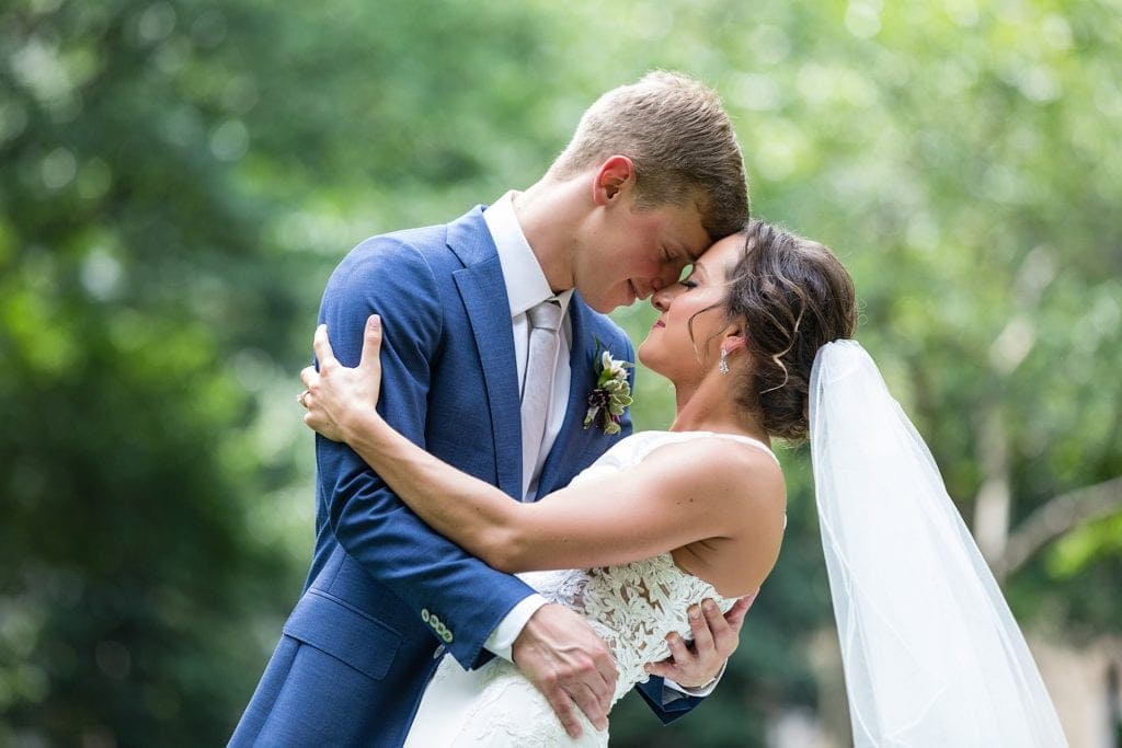 Bride & groom pose in Rittenhouse Square for their wedding portraits before their Kimmel Center wedding