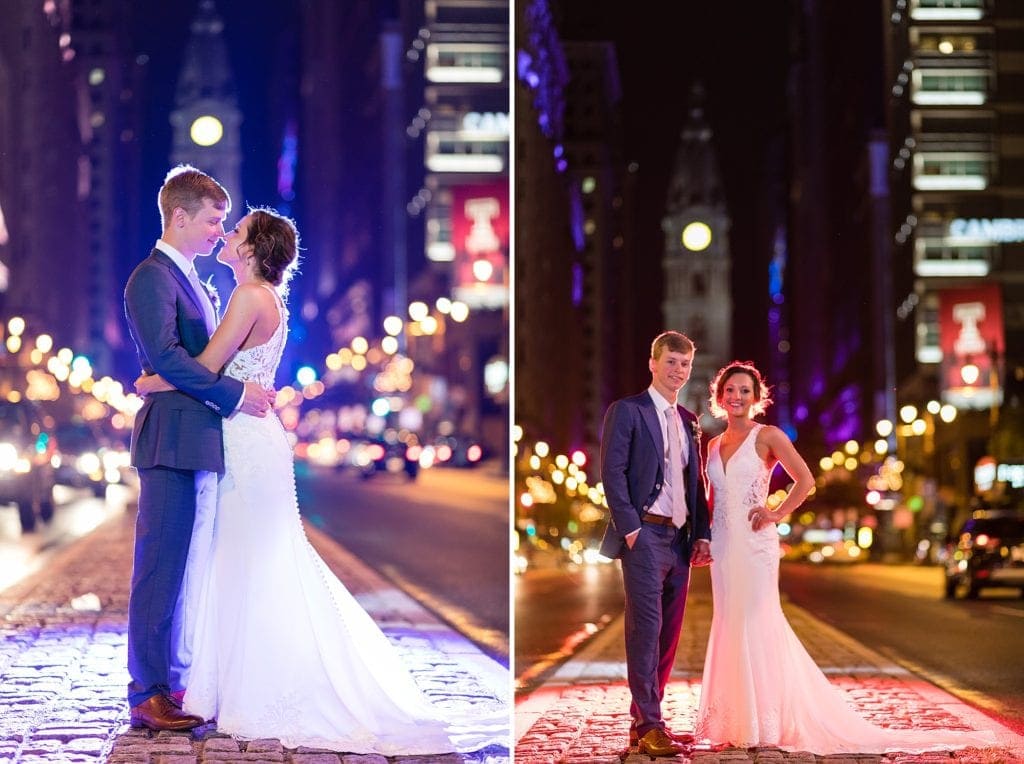 Black & white wedding photo of a bride & groom on Broad St in Philadelphia in front of City Hall as traffic rushes by