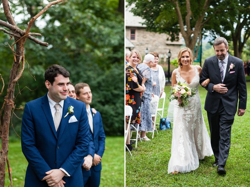 Groom smiles as bride walks down the aisle with her father during their Morris Arboretum wedding ceremony