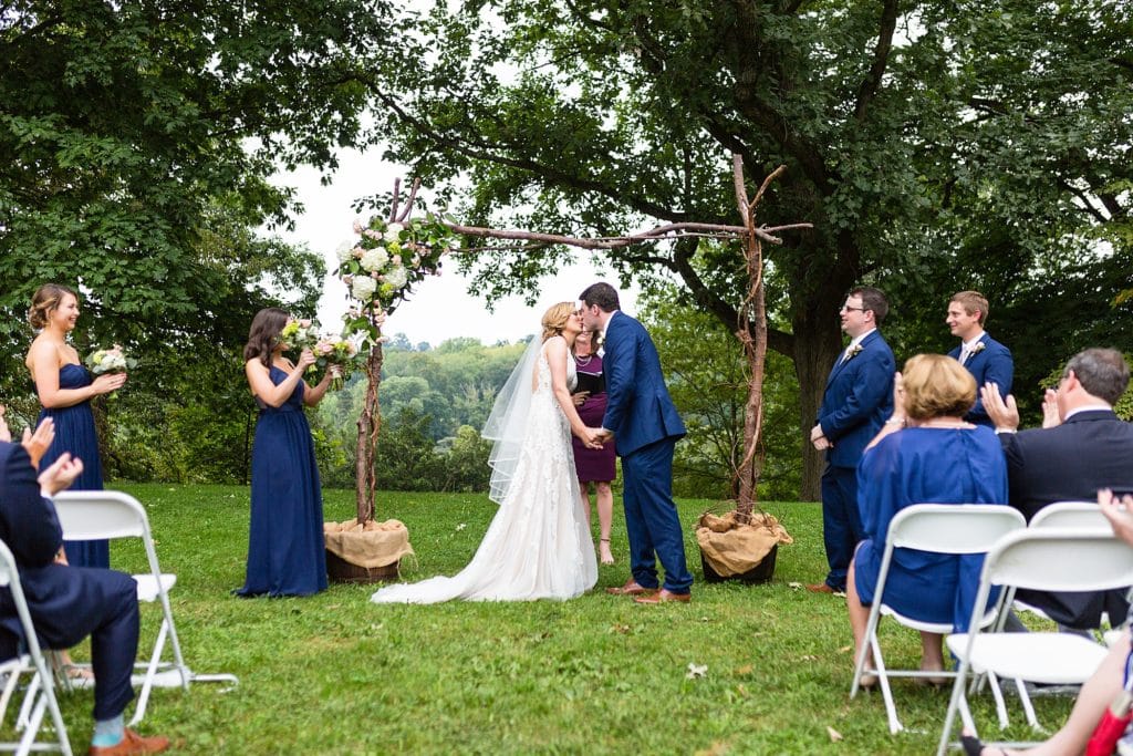 Bride & Groom share their first kiss during their Morris Arboretum wedding ceremony