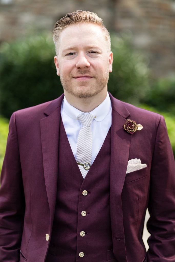 groom portrait in a burgundy Indochino suit