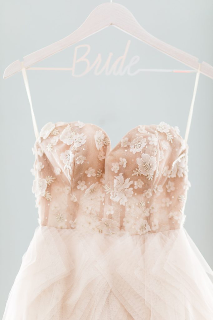 Floral fabric details on the bodice of a Lazaro wedding dress