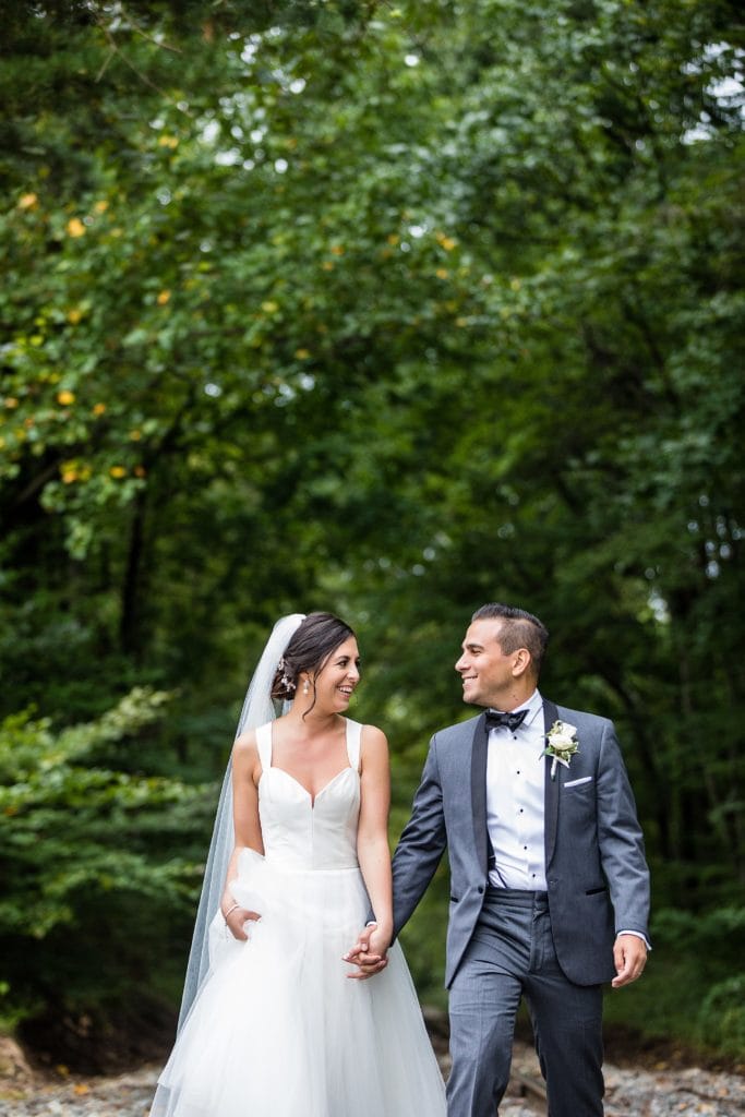 Groom & bride walk along the abandoned railway tracks behind the Mendenhall Inn | Ashley Gerrity Photography
