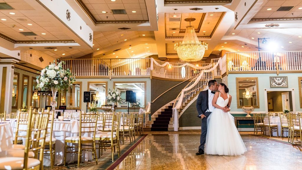 Bride & groom kiss in the gold ballroom at the Mendenhall Inn