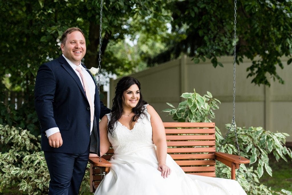 outdoor wedding portrait, bride sitting on tree swing, fun wedding portraits