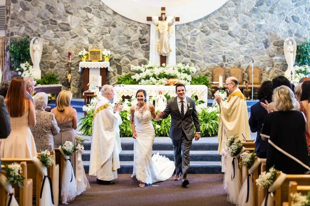 Bride and groom leaving the church as newlyweds | Ashley Gerrity Photography www.ashleygerrityphotography.com