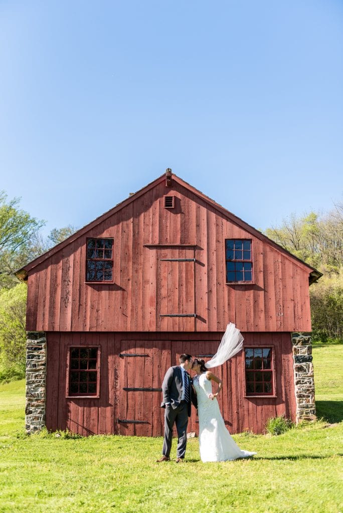 Bride and Groom by old red barn at brandywine battlefield park | Ashley Gerrity Photography www.ashleygerrityphotography.com