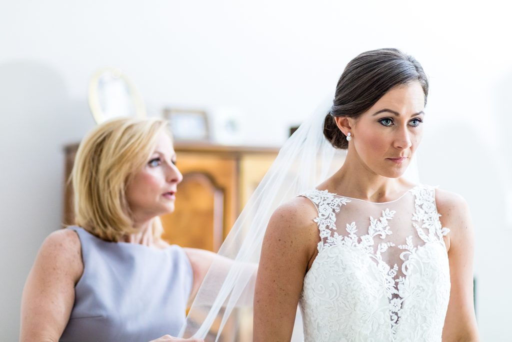 Mother of the bride helping the bride to put on her veil | Ashley Gerrity Photography www.ashleygerrityphotography.com