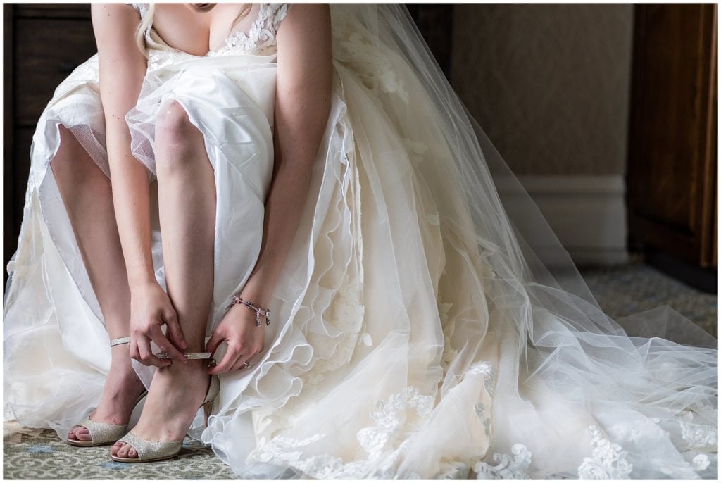 Bride putting on her Jimmy Choo Shoes at Union League Golf Club Wedding | Ashley Gerrity Photography www.ashleygerrityphotography.com