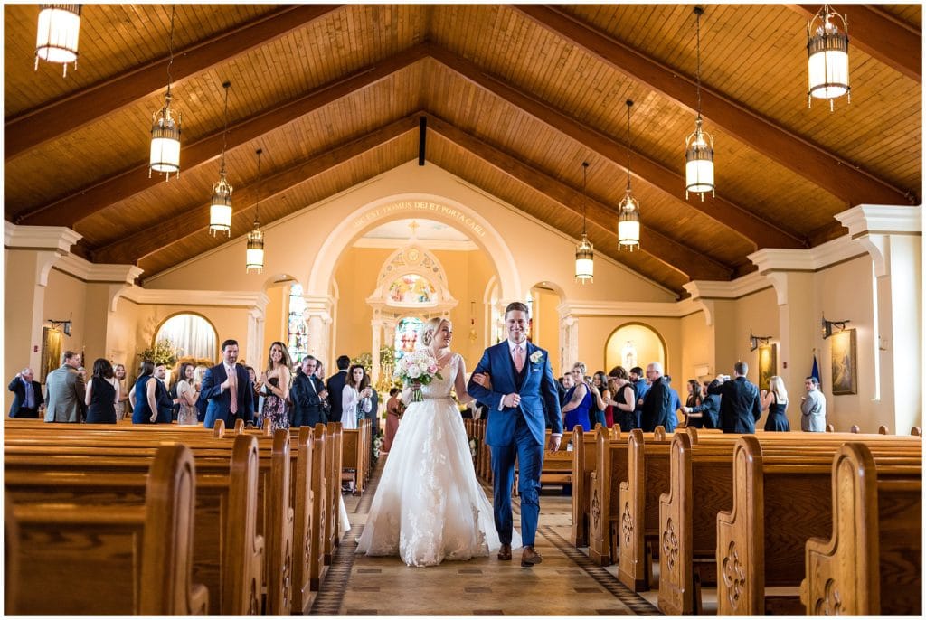 Newlyweds make their way back up the aisle | Ashley Gerrity Photography www.ashleygerrityphotography.com