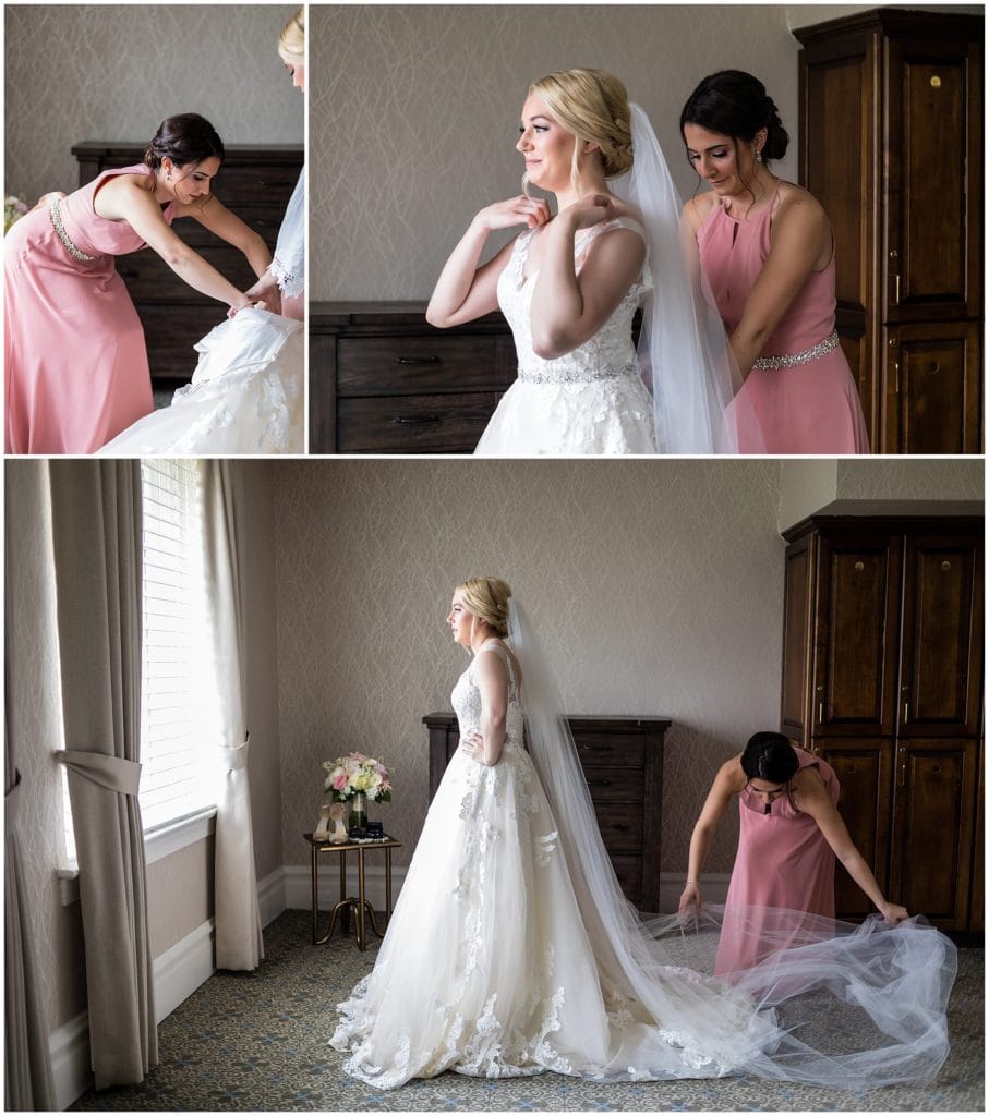 Maid of honor helps bride put on her Maggie Sottero dress at Union League Golf Club Wedding | Ashley Gerrity Photography www.ashleygerrityphotography.com
