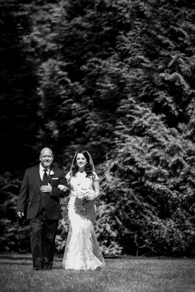 Bride being escorted by her father | Ashley Gerrity Photography www.ashleygerrityphotography.com