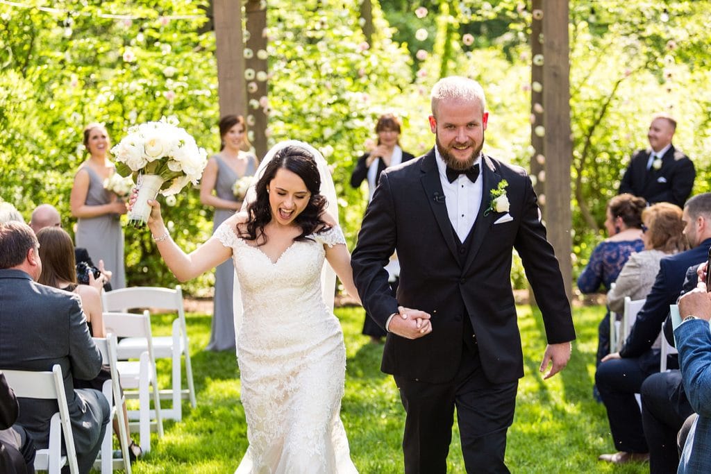 Bride and groom walk up the aisle celebrating being married | Ashley Gerrity Photography www.ashleygerrityphotography.com